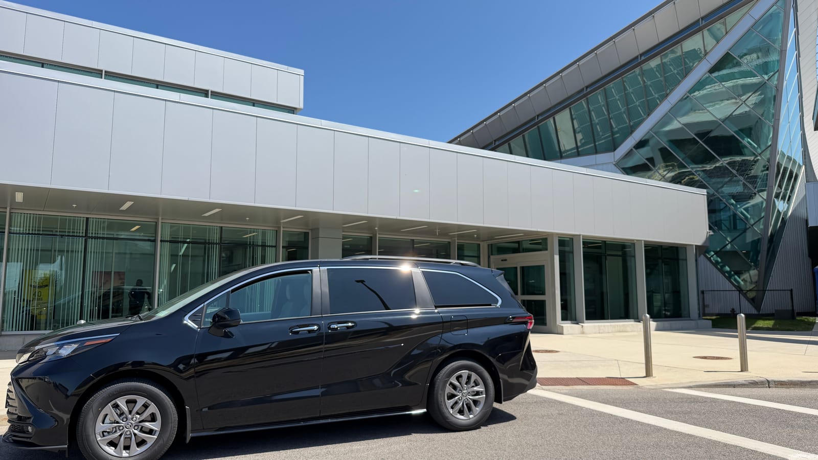 Black Toyota Sienna taxi waiting outside the Buffalo Airport terminal doors
