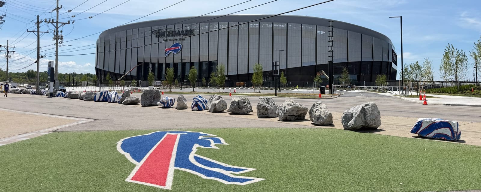 Highmark Stadium in Orchard Park, New York, with the Buffalo Bills logo on the turf in the foreground